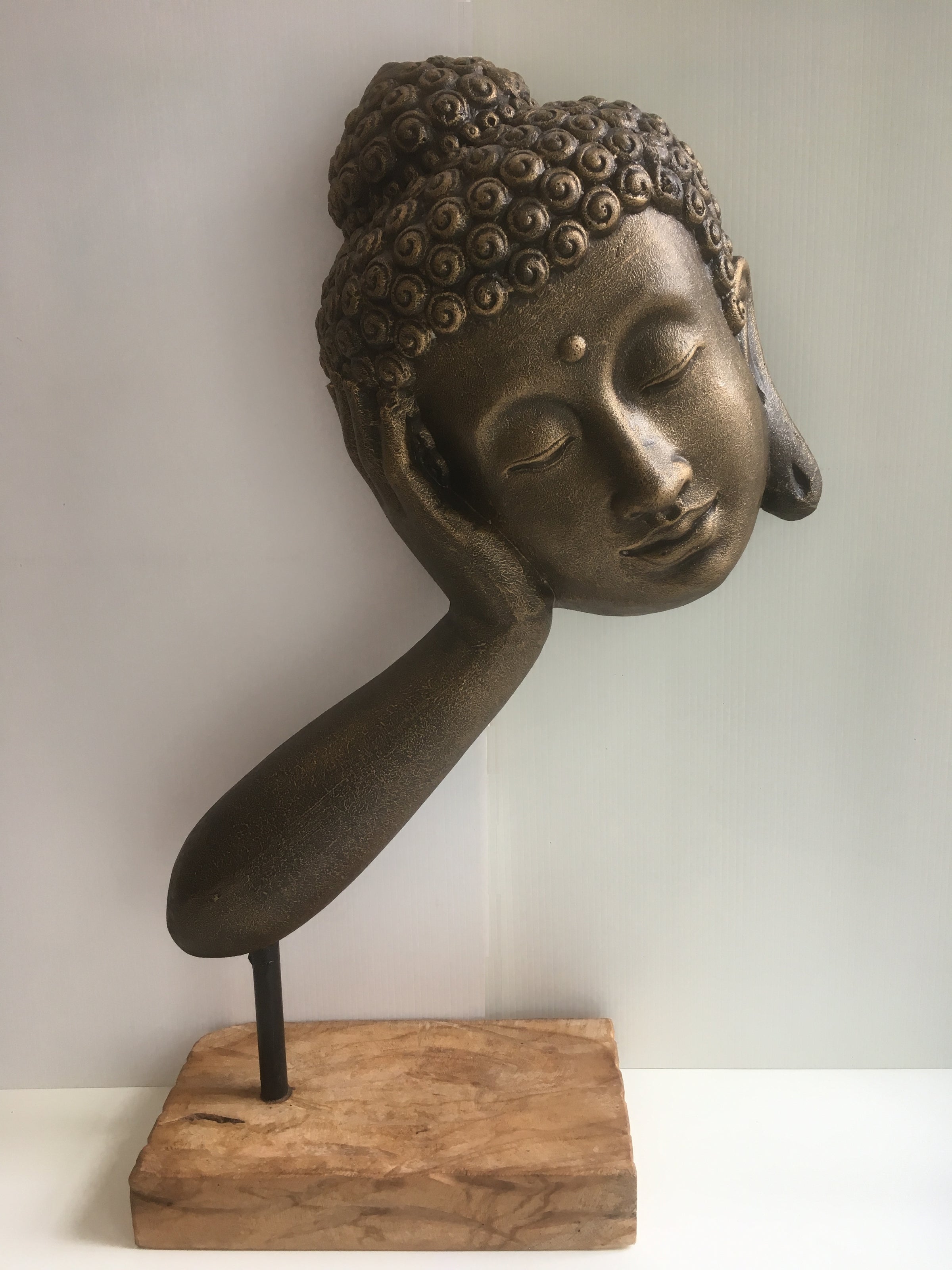 Resting Buddha head on Arm